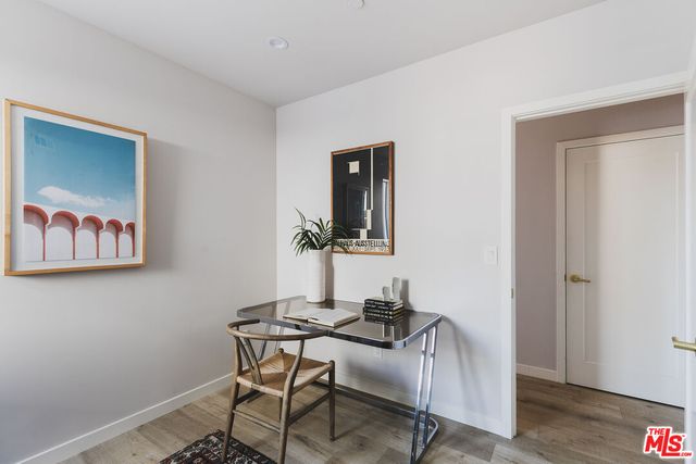 a view of a workspace with furniture and wooden floor