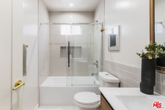 a bathroom with a toilet a sink and bathtub