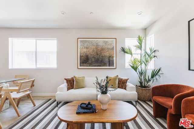 a living room with furniture flowerpot and a window