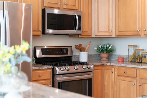 a kitchen with stainless steel appliances a stove a microwave and cabinets