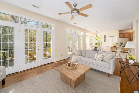 a roof deck with couches and wooden fence
