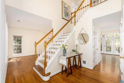 a view of entryway and hall with wooden floor