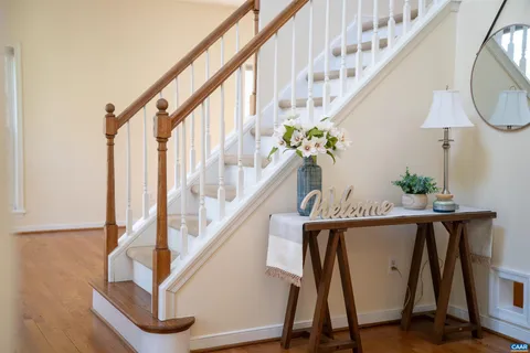 a spacious bathroom with a double vanity sink a large mirror a bathtub and next to a window