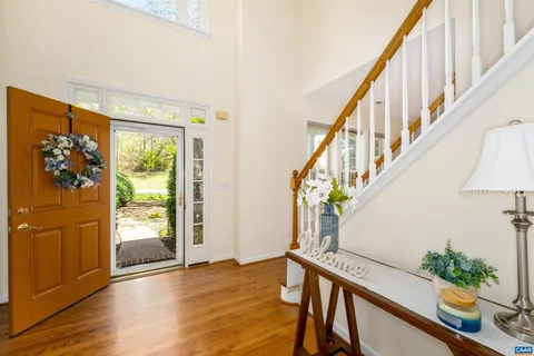 a view of an entryway with wooden floor and stairs
