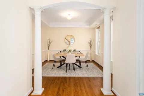 a dining room with furniture and wooden floor