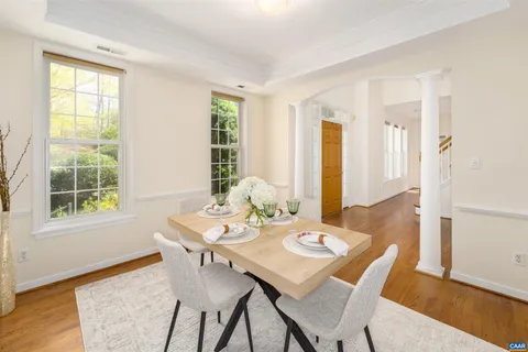 a view of a dining room with furniture and wooden floor