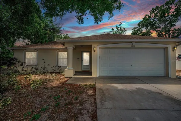 a view of backyard with a slide and wooden fence