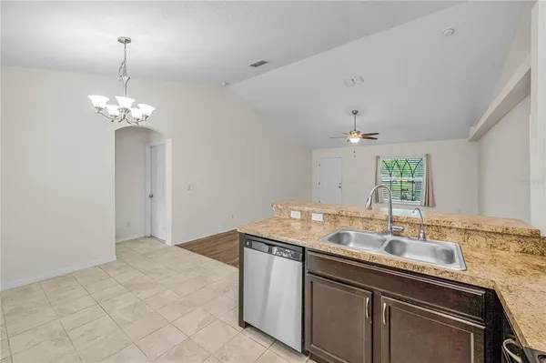 a bathroom with a granite countertop toilet sink and mirror