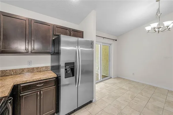 a bathroom with a granite countertop sink a toilet a mirror and shower