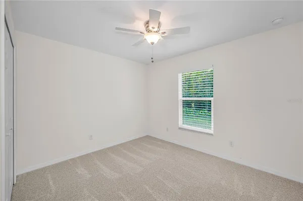a view of a house with a yard and tree