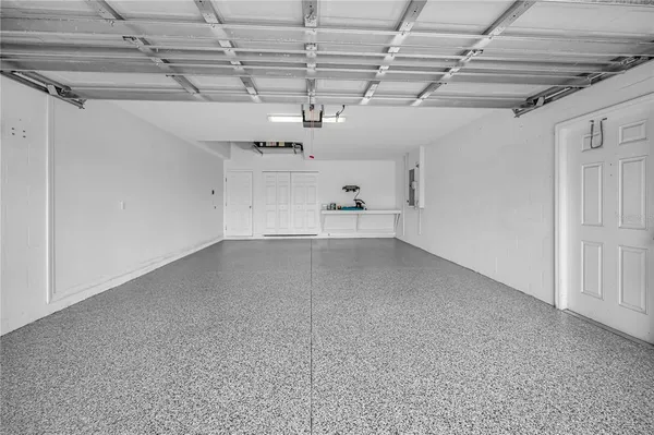 a view of backyard with a table and chairs and potted plants