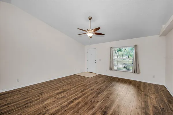 a kitchen with stainless steel appliances granite countertop a refrigerator a stove and a sink with wooden floors