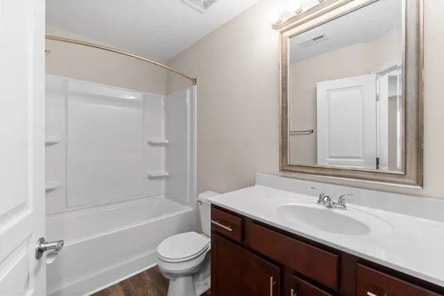 a bathroom with a sink a toilet and a bathtub