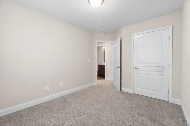 a view of an empty room and closet area