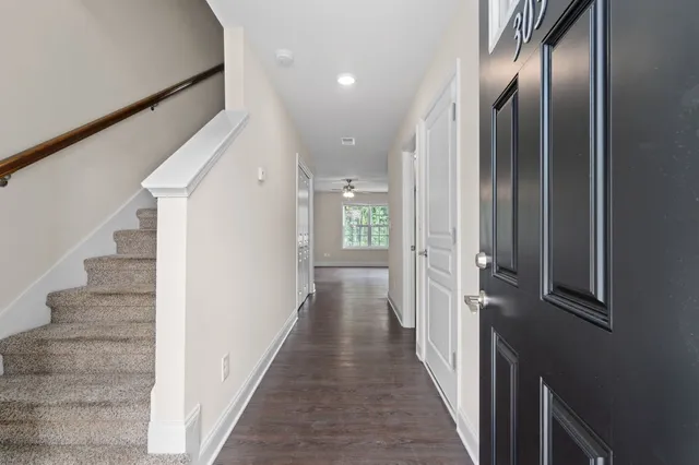 a view of a hallway with wooden floor
