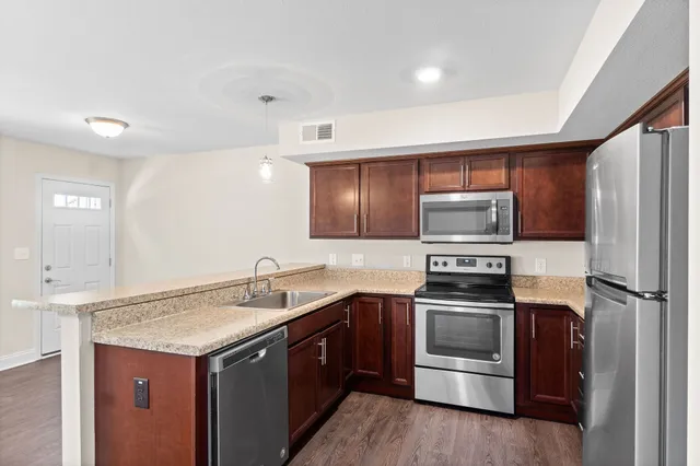 a kitchen with a sink a stove and refrigerator