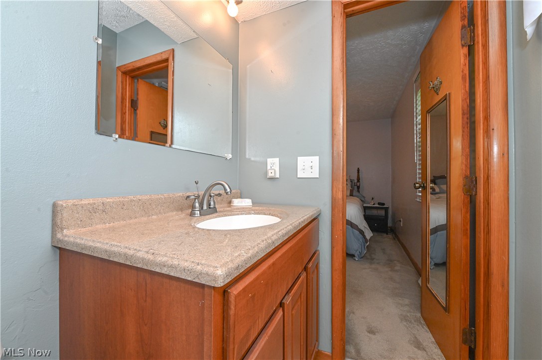 13425 Chardon-Windsor Road Chardon, OH 44024 - Photo 32 of 50 Bathroom with oversized vanity and a textured ceiling