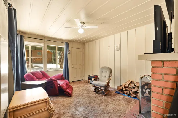 a bedroom with furniture and a large window