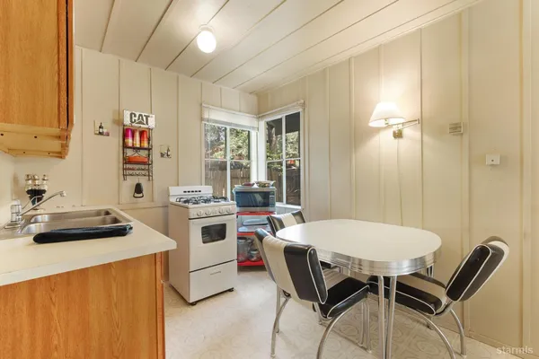 a kitchen that has a table and chairs in it