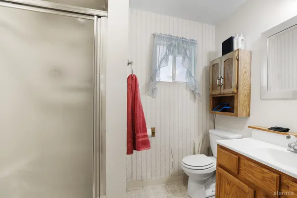 a bathroom with a toilet sink and a shower