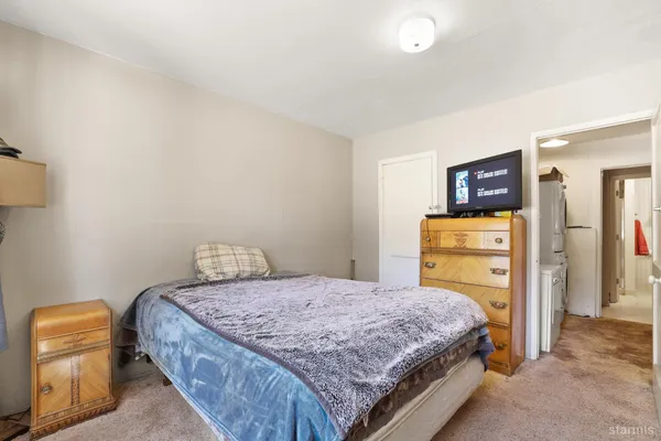 a bedroom with a bed and a couch