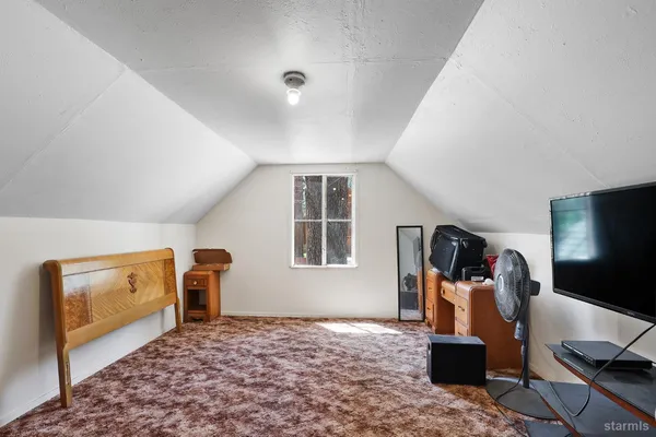 a bed room with a bed and a television