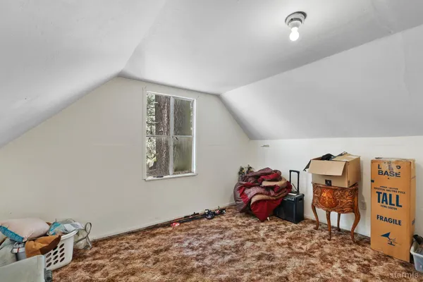 a bedroom with bed and a window