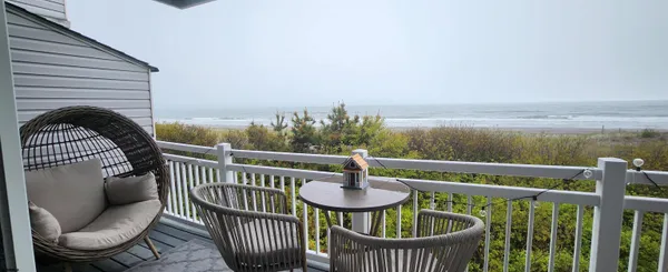 a view of a roof deck with furniture