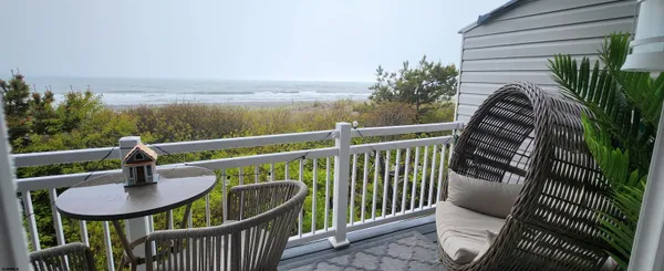 a balcony with a table and chairs