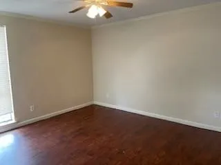 an empty room with a chandelier fan