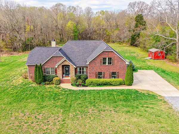 an aerial view of a house with yard swimming pool and outdoor seating