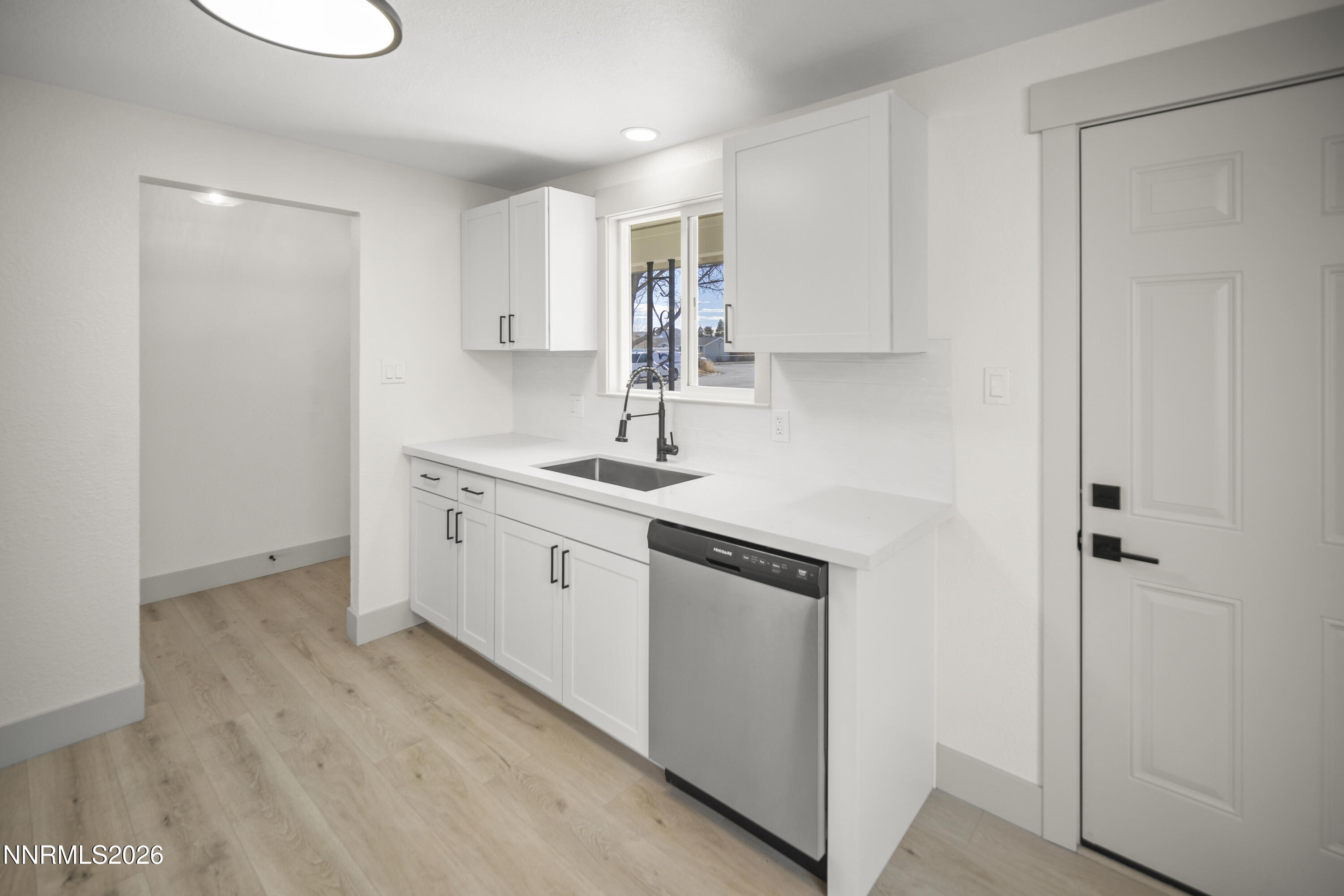 308 Shawna Way Yerington, NV 89447 - Photo 11 of 37 a kitchen with a sink cabinets and wooden floor