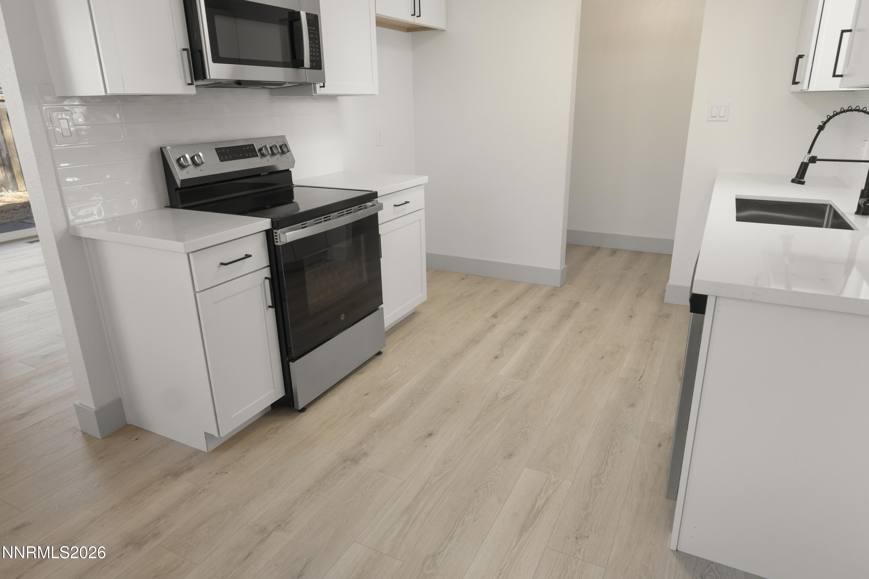 308 Shawna Way Yerington, NV 89447 - Photo 13 of 37 a kitchen with a stove and a microwave