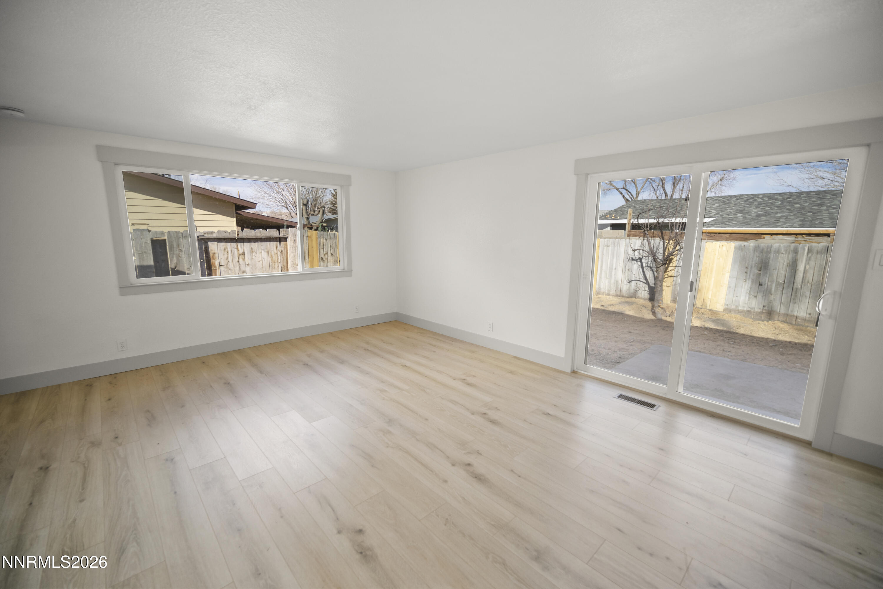 308 Shawna Way Yerington, NV 89447 - Photo 15 of 37 an empty room with wooden floor and windows