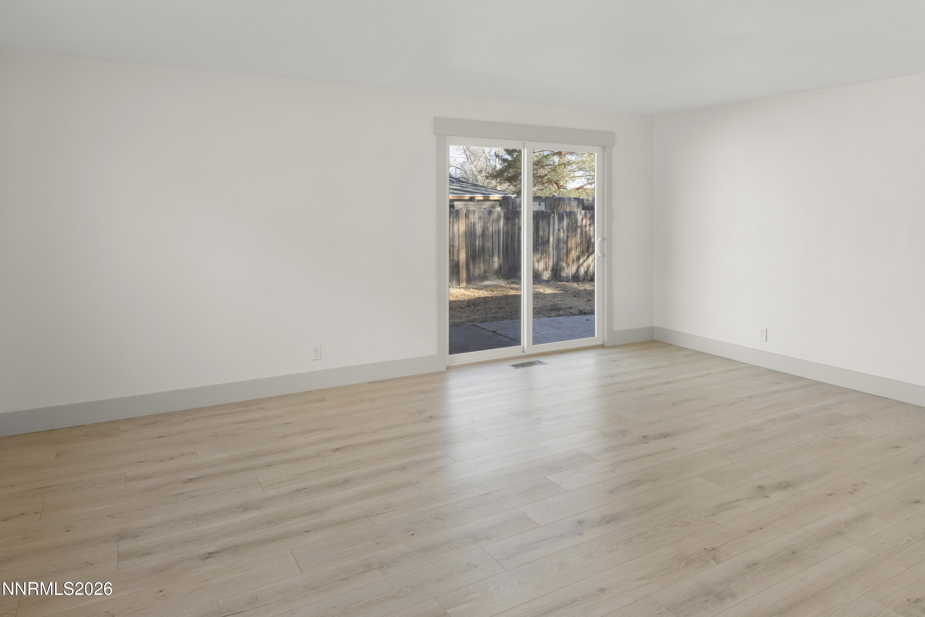 308 Shawna Way Yerington, NV 89447 - Photo 16 of 37 an empty room with wooden floor and windows