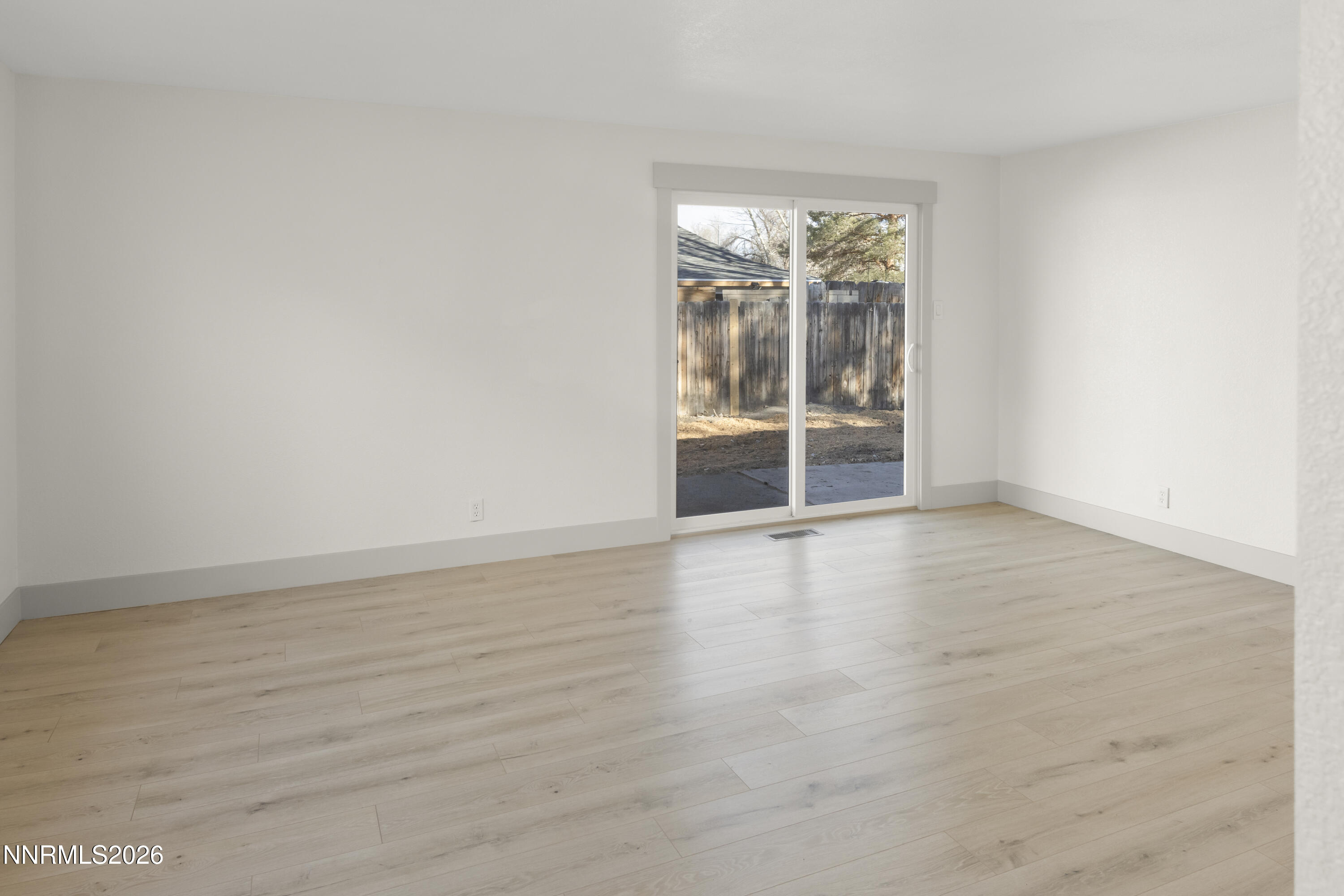 308 Shawna Way Yerington, NV 89447 - Photo 17 of 37 an empty room with wooden floor and windows