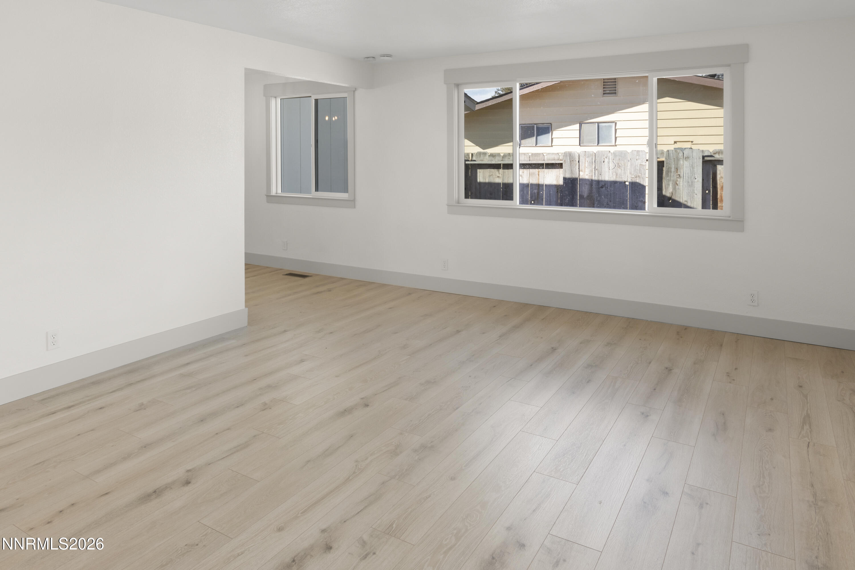 308 Shawna Way Yerington, NV 89447 - Photo 18 of 37 a view of an empty room with wooden floor and a window