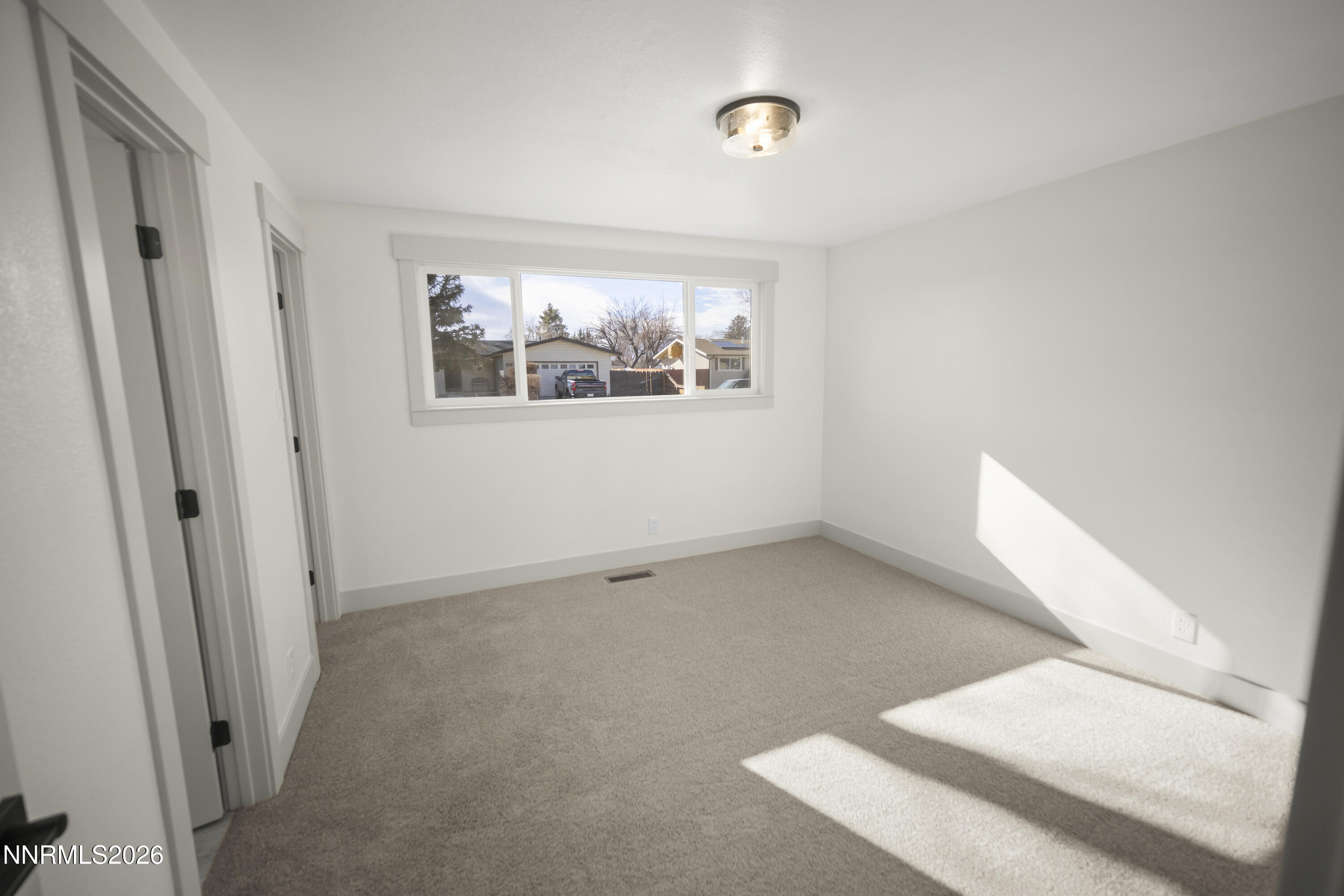 308 Shawna Way Yerington, NV 89447 - Photo 19 of 37 an empty room with windows