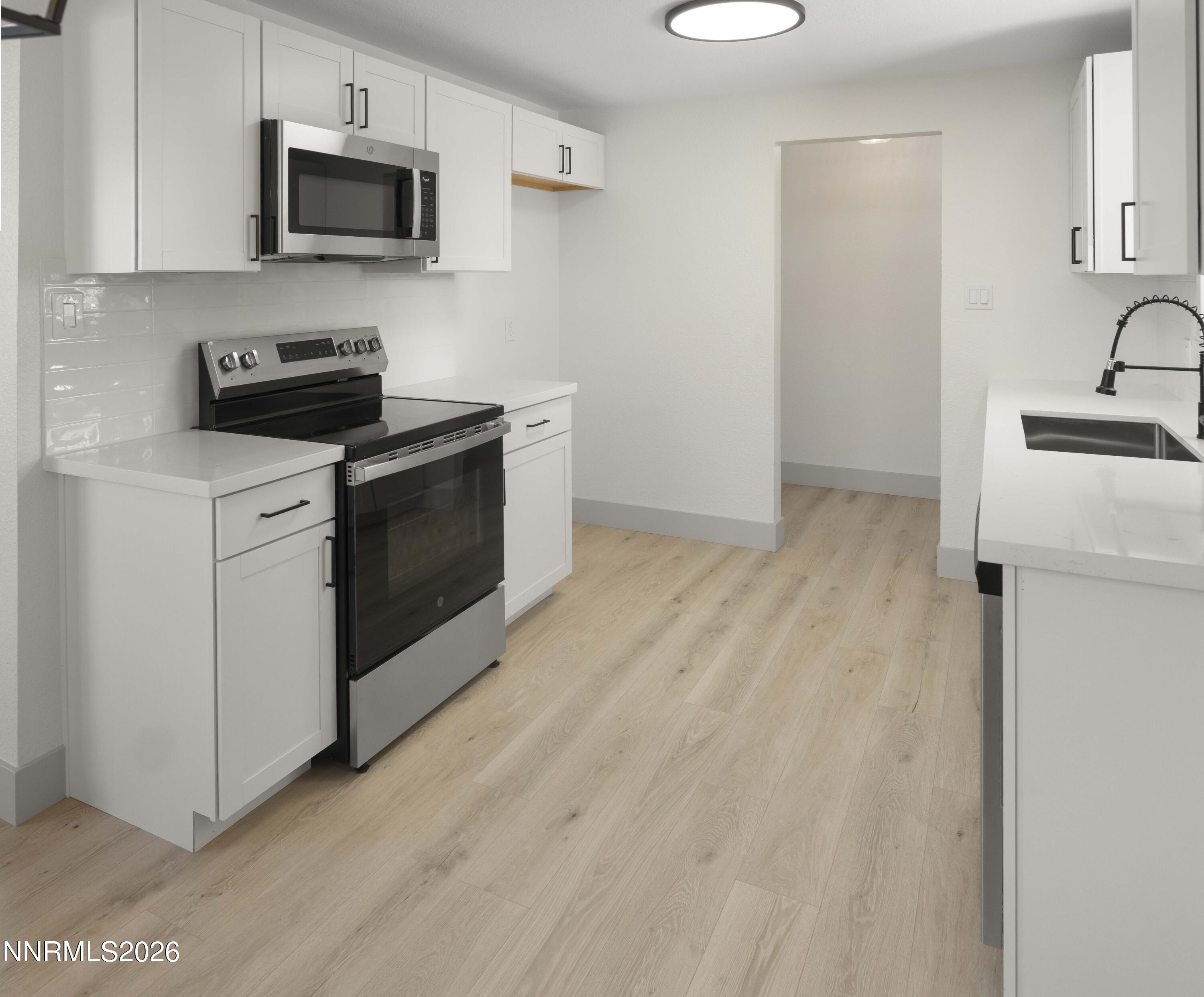 308 Shawna Way Yerington, NV 89447 - Photo 7 of 37 a kitchen with a sink and a microwave