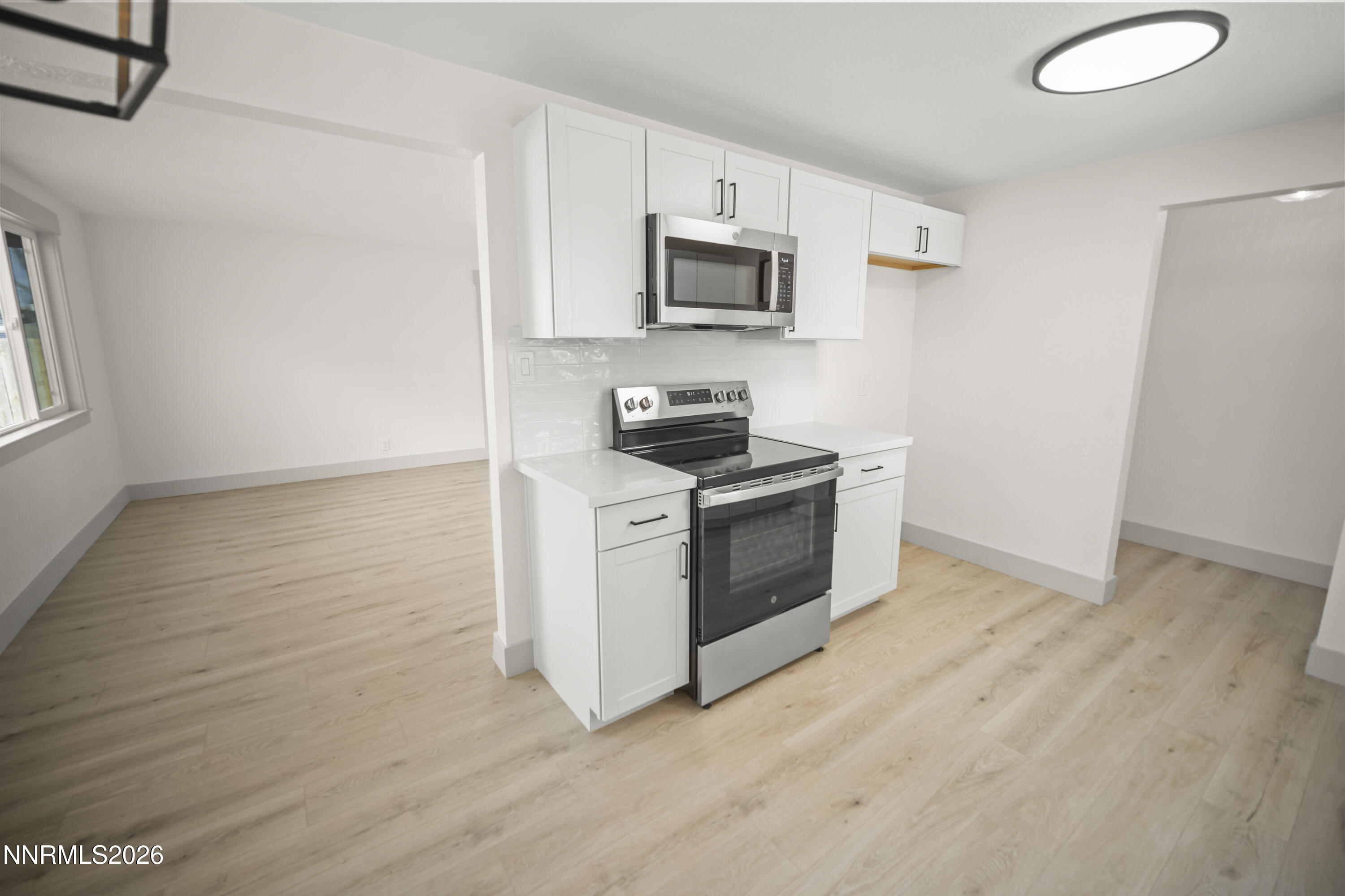 308 Shawna Way Yerington, NV 89447 - Photo 10 of 37 a kitchen with granite countertop a stove top oven and sink
