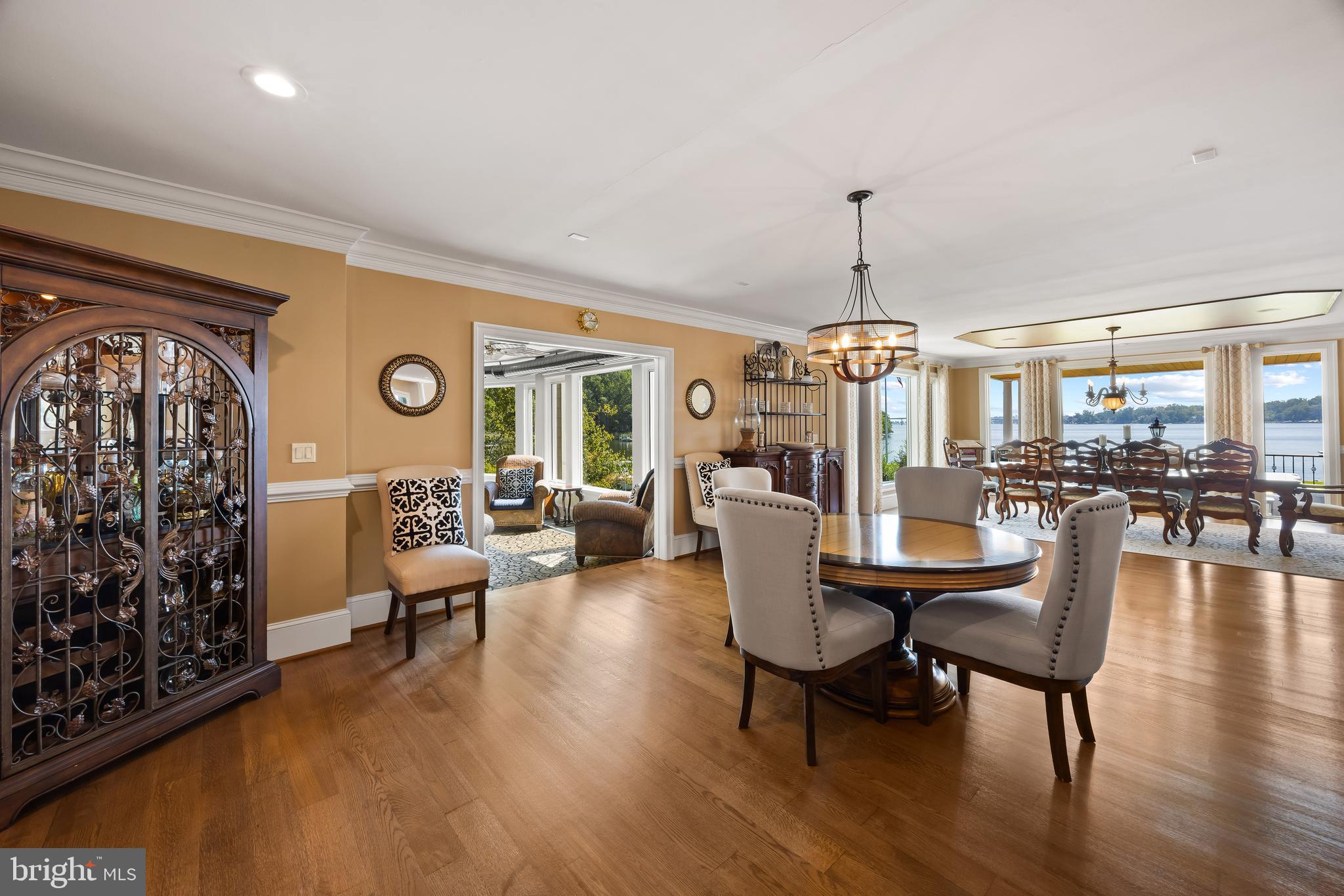 125 South Winchester Road Annapolis, MD 21409 - Photo 15 of 47 a dining room with wooden floor a chandelier a glass table and chairs
