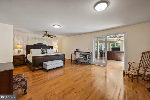 a bedroom with furniture and a wooden floor