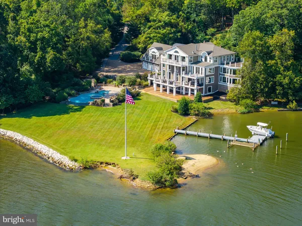 an aerial view of residential houses with outdoor space and swimming pool