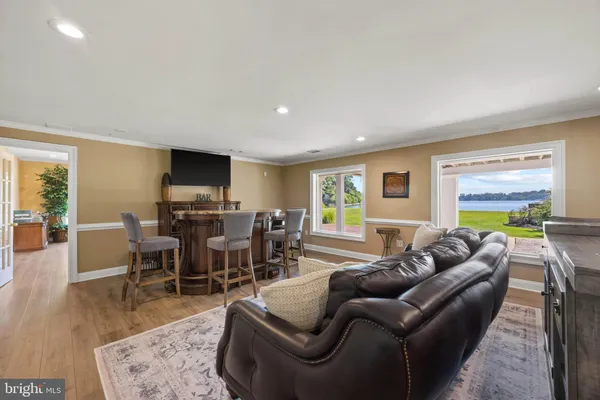a living room with furniture a wooden floor and a window