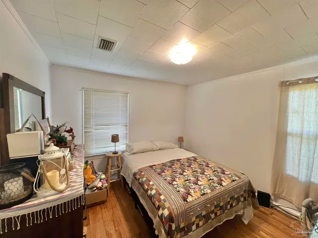 a bedroom with a bed a table and chair