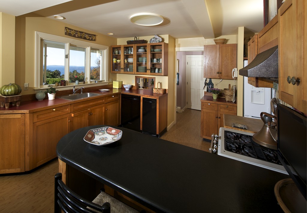 301 Summer Street Manchester, MA 01944 - Photo 11 of 22 a kitchen with a table and chairs in it
