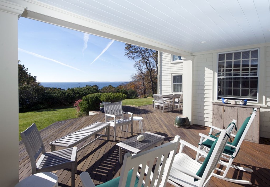 301 Summer Street Manchester, MA 01944 - Photo 7 of 22 a view of a patio with table and chairs with wooden floor and fence