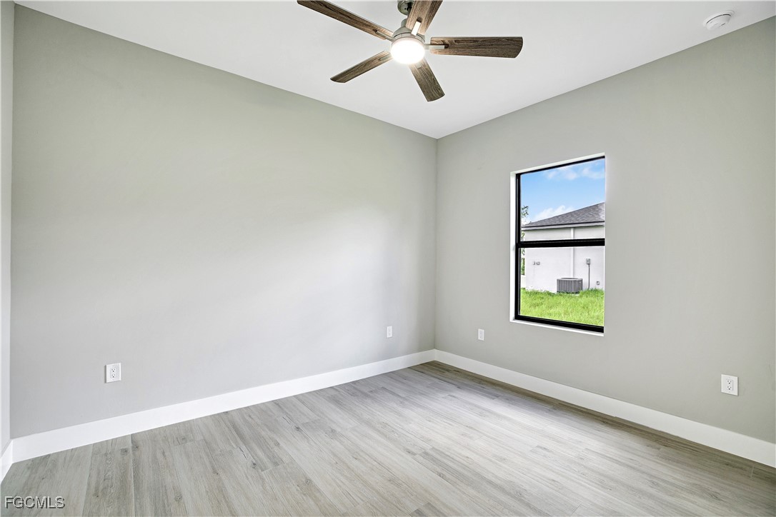 4846 30th Street Southwest Lehigh Acres, FL 33973 - Photo 12 of 14 an empty room with a window and a ceiling fan