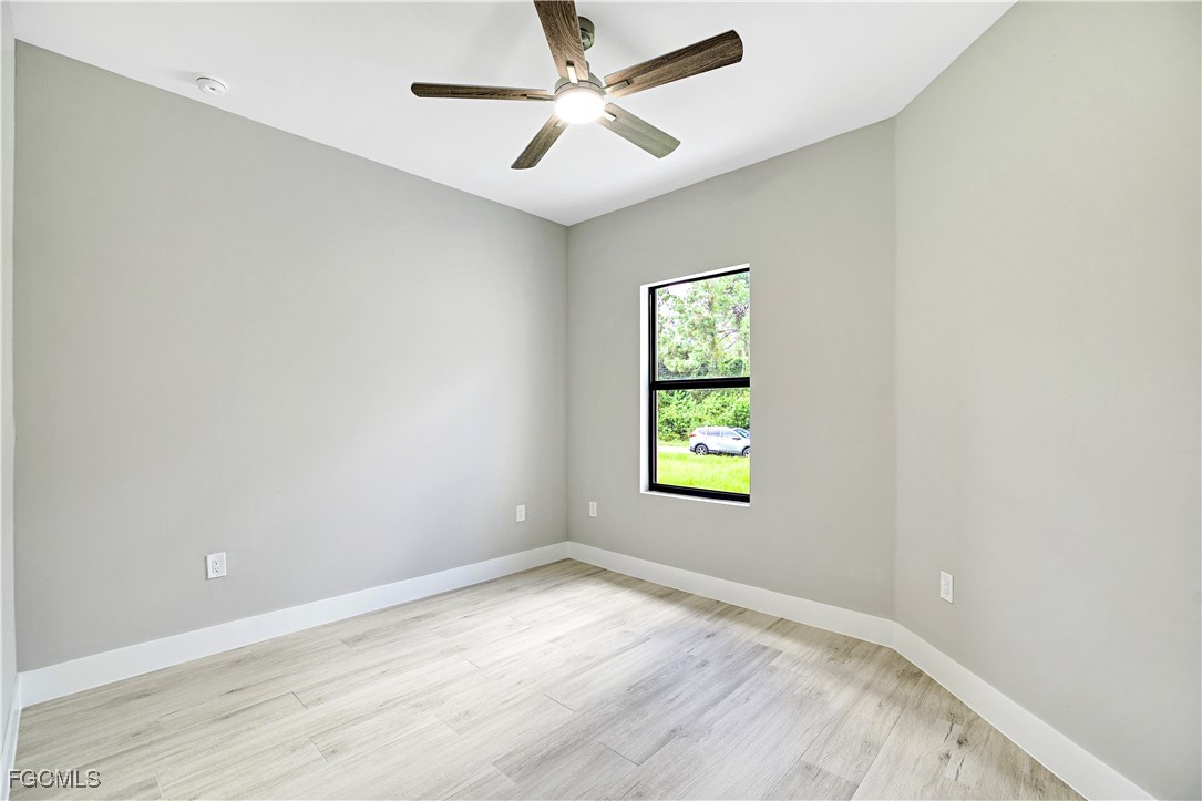 4846 30th Street Southwest Lehigh Acres, FL 33973 - Photo 10 of 14 an empty room with a window and a fan