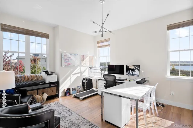 a room with furniture pool table and windows